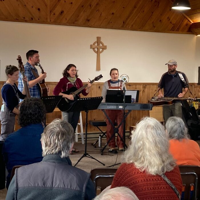 A band plays in front of an audience in the Sunrise Chapel.